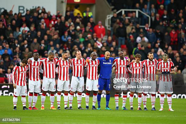 Stoke City players observe a minutes silence for the victims of the plane crash involving the Brazilian club Chapecoense prior to the Premier League...