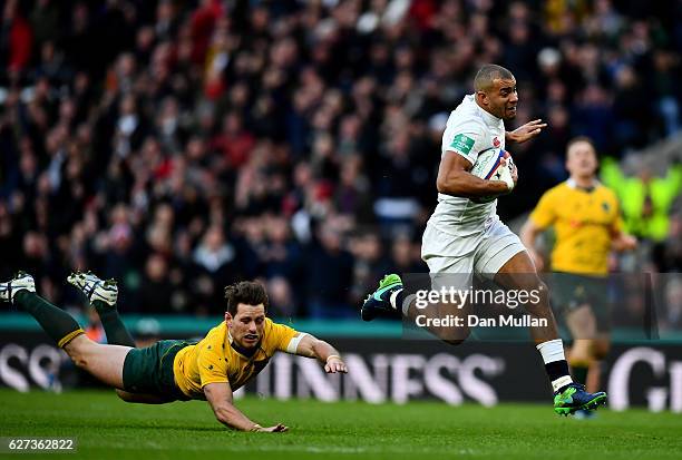 Jonathan Joseph of England scores his sides first try while Bernard Foley of Australia attempts to tackle him during the Old Mutual Wealth Series...