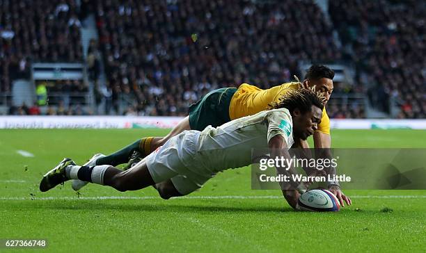 Marland Yarde of England scores his sides second try while Israel Folau of Australia attempts to stop him during the Old Mutual Wealth Series match...