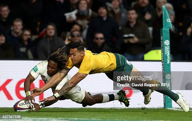 Marland Yarde of England scores his sides second try while Israel Folau of Australia attempts to stop him during the Old Mutual Wealth Series match...