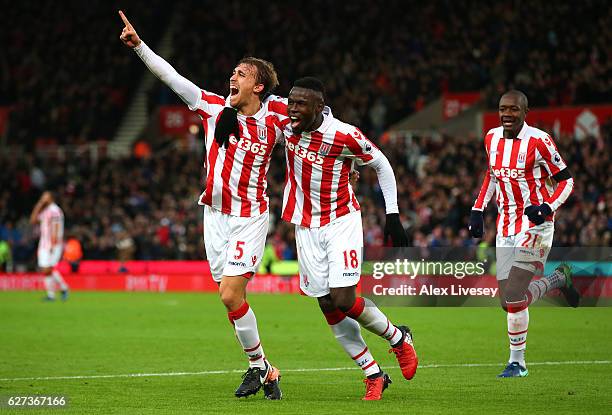 Marc Muniesa of Stoke City celebrates scoring his team's second goal with his team mate Mame Biram Diouf during the Premier League match between...