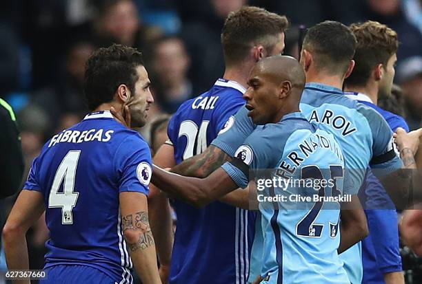 Cesc Fabregas of Chelsea and Fernandinho of Manchester City clash during the Premier League match between Manchester City and Chelsea at Etihad...