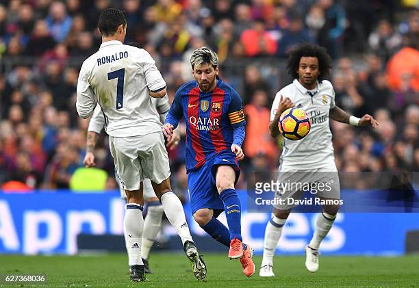 Lionel Messi of Barcelona and Cristiano Ronaldo of Real Madrid compete for the ball during the La Liga match between FC Barcelona and Real Madrid CF...
