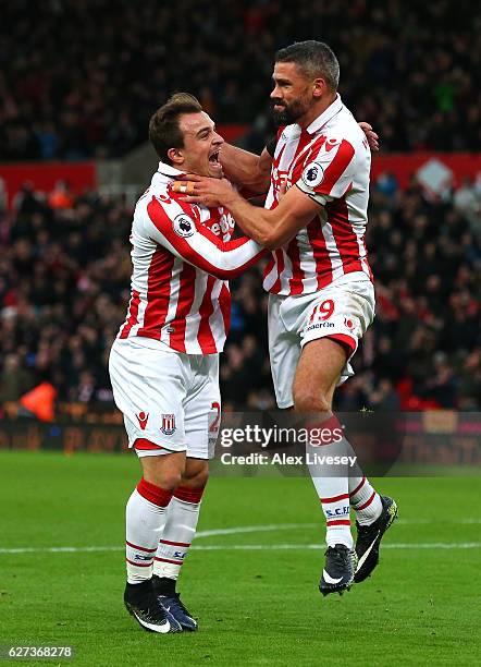 Jonathan Walters of Stoke City celebrates scoring his team's first goal with his team mates Xherdan Shaqiri during the Premier League match between...