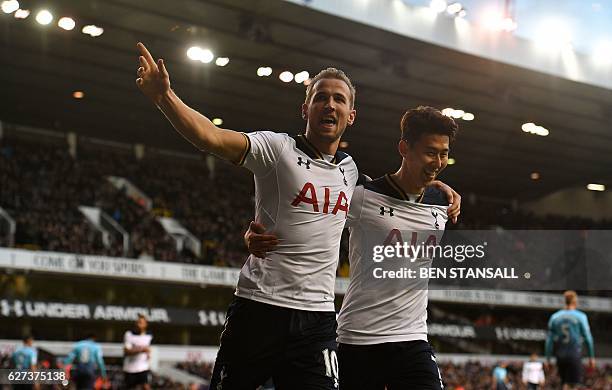 Tottenham Hotspur's English striker Harry Kane celebrates with Tottenham Hotspur's South Korean striker Son Heung-Min after shooting from the penalty...