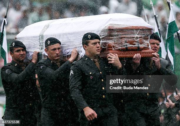 Air Force troops carry coffin of one of the victims of the plane crash in Colombia at the Arena Conda stadium on December 03, 2016 in Chapeco,...