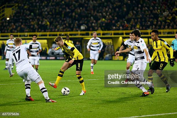 Marco Reus of Dortmund passes the ball to Pierre-Emerick Aubameyang of Dortmund and he scores the forth goal during the Bundesliga match between...