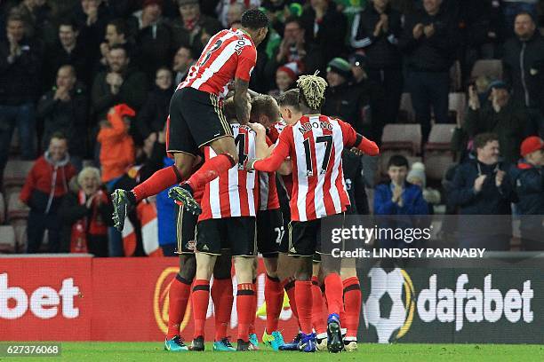 Sunderland players celebrate after a header from Sunderland's German defender Jan Kirchhoff caused Leicester City's German defender Robert Huth to...