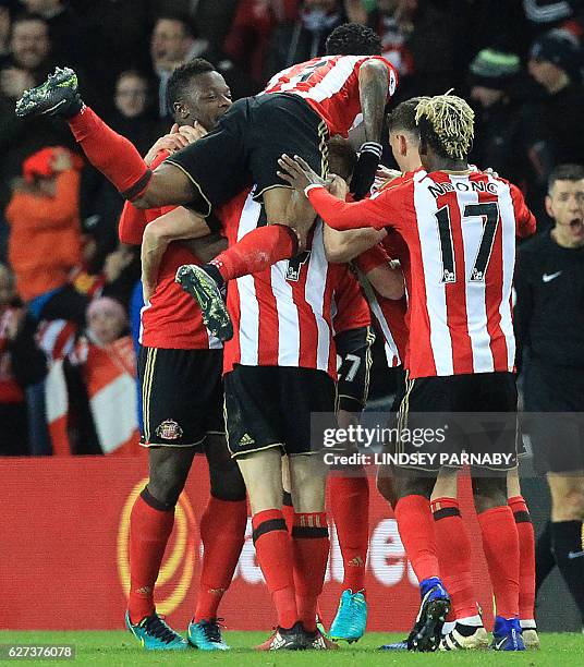 Sunderland players celebrate after a header from Sunderland's German defender Jan Kirchhoff caused Leicester City's German defender Robert Huth to...