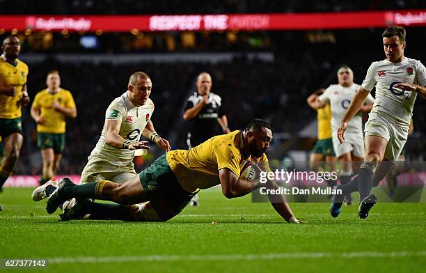 Sekope Kepu of Australia celebrates scoring his sides third try as Mike Brown of England attempts to catch him during the Old Mutual Wealth Series...