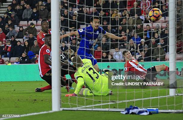 Leicester City's Japanese striker Shinji Okazaki shoots past Sunderland's English goalkeeper Jordan Pickford to scores his team's first goal during...