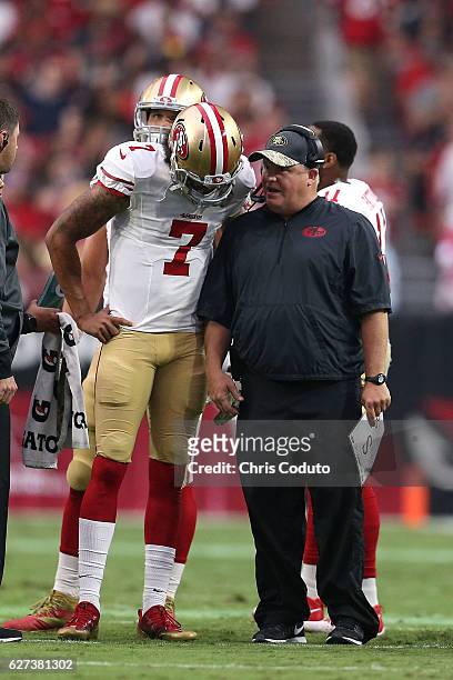 Head coach Chip Kelly of the San Francisco 49ers talks with quarterback Colin Kaepernick during the first half of the NFL football game against the...
