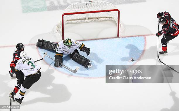 Kevin Hancock of the Owen Sound Attack fails to score on Tyler Parsons of the London Knights during an OHL game at Budweiser Gardens on December 2,...