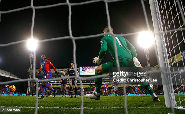 Christian Benteke of Crystal Palace scores their third goal past goalkeeper Fraser Forster of Southampton during the Premier League match between...
