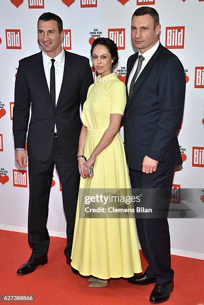 Wladimir Klitschko, Natalia Klitschko and Vitali Klitschko attend the Ein Herz Fuer Kinder Gala 2016 on December 3, 2016 in Berlin, Germany.