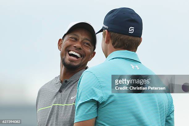 Tiger Woods of the United States and Jordan Spieth of the United States laugh on the practice range during round three of the Hero World Challenge at...