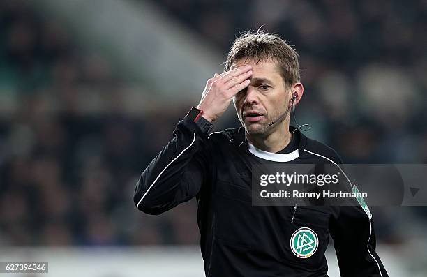 Referee Jochen Drees reacts during the Bundesliga match between VfL Wolfsburg and Hertha BSC at Volkswagen Arena on December 3, 2016 in Wolfsburg,...