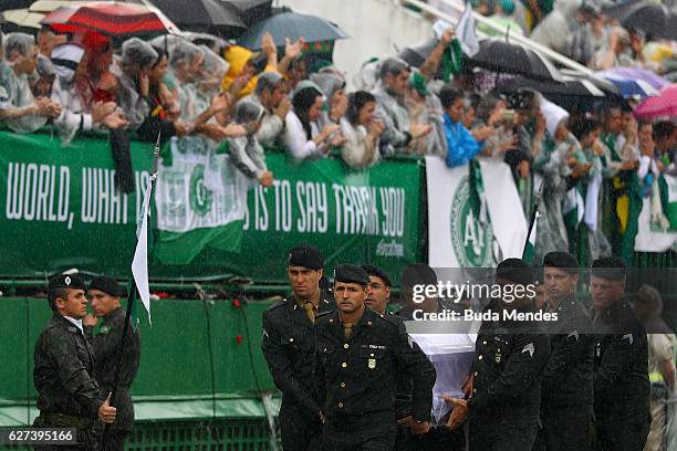 Air Force troops carry coffin of one of the victims of the plane crash in Colombia at the Arena Conda stadium on December 03, 2016 in Chapeco,...