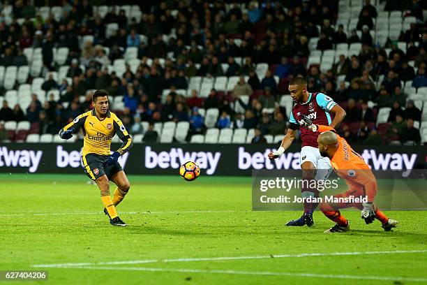 Alexis Sanchez of Arsenal beats goalkeeper Darren Randolph of West Ham United as he scores his team's fifth goal and completes his hat trick during...
