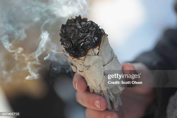 Sage which is used during a smudging ceremony burns at Oceti Sakowin Camp on the edge of the Standing Rock Sioux Reservation on December 3, 2016...