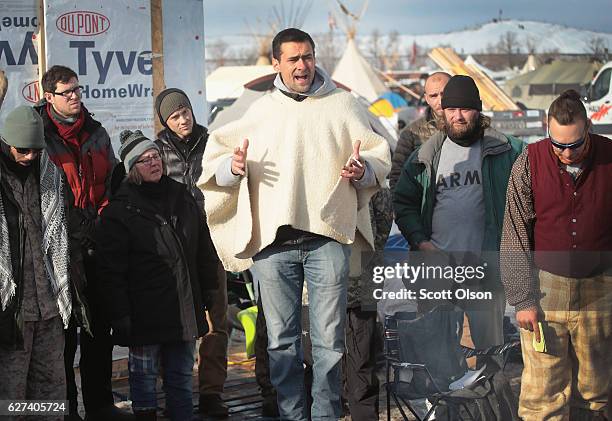 Wes Clark Jr., co-coordinator of #VeteransForStandingRock, briefs military veterans on camp rules and their mission at Oceti Sakowin Camp on the edge...