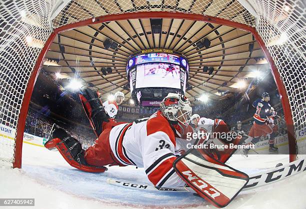 Derek Stepan of the New York Rangers scores at 4:05 of the first period against Michael Leighton of the Carolina Hurricanes at Madison Square Garden...
