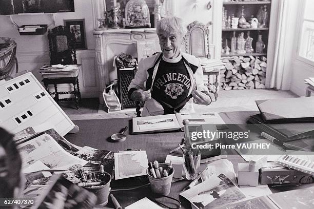 French photographer Jacques-Henri Lartigue shows off his Princeton sweatshirt while working in his Paris home.