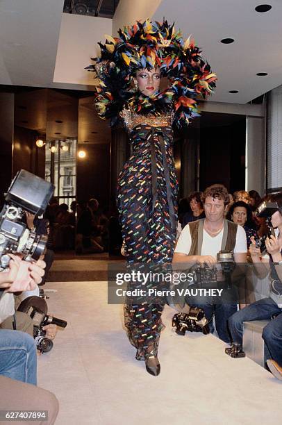 French designer Hubert de Givenchy shows his 1979-1980 fall-winter women's haute couture collection in Paris. The model is wearing a patterned dress...