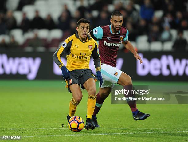 Alexis Sanchez breaks past West Ham defender Winston Reid to score the 5th Arsenal goal during the Premier League match between West Ham United and...