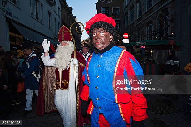 Black Pete, who is traditionally depicted as the helper of Saint-Nicholas, walks in front on the annual parade of Saint-Nicholas through Brussels....