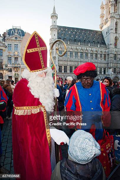 Black Pete, traditionally the helper of Saint-Nicholas and St-Nicholas talk to the children on the annual parade of Saint-Nicholas through Brussels....