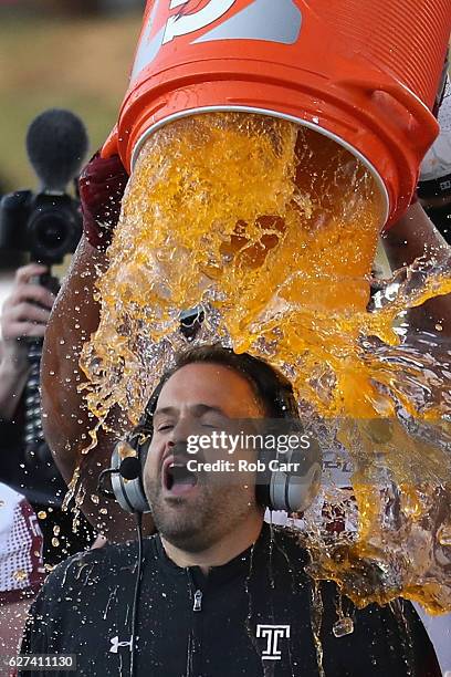 Head coach Matt Rhule of the Temple Owls is doused during the closing moments of the Owls 34-10 win over the Navy Midshipmen during the AAC...