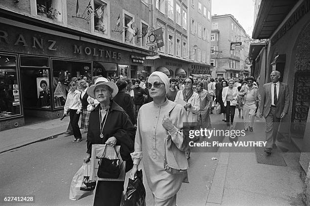 Princess Grace of Monaco walks down a crowed street while shopping in Salzburg, Austria.