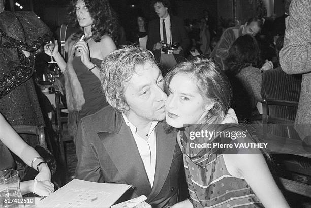 French actor Serge Gainsbourg kisses his wife, actress and model Bambou, on the cheek. The couple attended a party to inaugurate the new roulette...