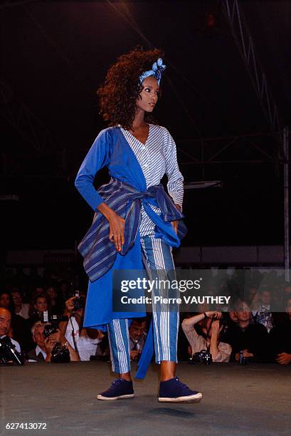 Japanese design house Kenzo shows its 1986 spring-summer women's ready-to-wear line in Paris. Model Iman is wearing a blue and white striped outfit.