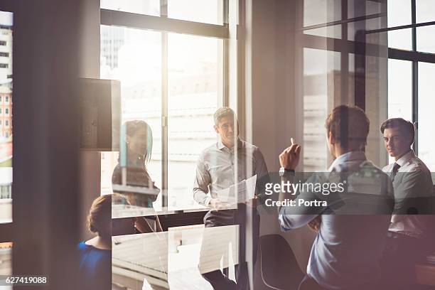 business people having discussion in board room - business meeting stockfoto's en -beelden
