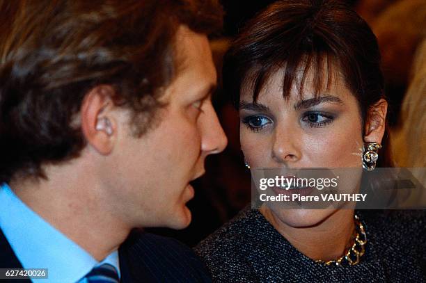 Princess Caroline of Monaco talks with her husband, Stefano Casiraghi, at the Dior 1985 Spring-Summer haute couture fashion show in Paris.