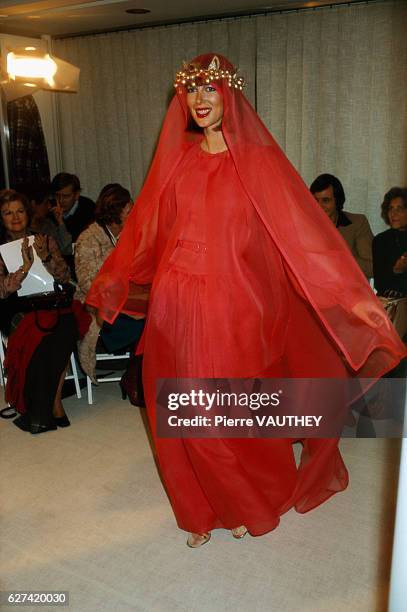 Fashion model wears a red haute couture evening gown with a matching veil by French fashion designer Jules-Francois Crahay for the Lanvin fashion...