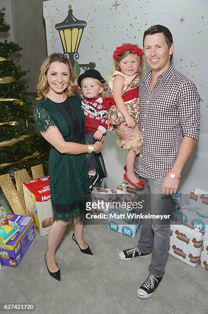 Actress Beverley Mitchell and husband Michael Cameron, with their children Hutton Michael Cameron and Kenzie Cameron attend 6th Annual Santa's Secret...