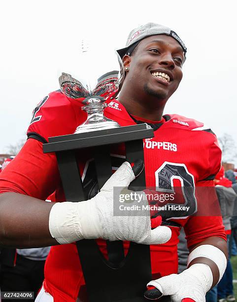 Darrell Williams Jr. #62 of the Western Kentucky Hilltoppers carries the championship trophy off the field following the CUSA Championship game...