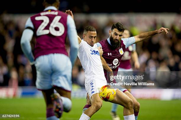 Mile Jedinak of Aston Villa is challenged by Kemar Roofe of Leeds United during the Sky Bet Championship match between Leeds United and Aston Villa...