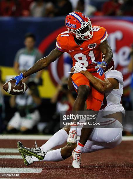Antonio Callaway of the Florida Gators scores a first quarter touchdown as Minkah Fitzpatrick of the Alabama Crimson Tide defends during the SEC...