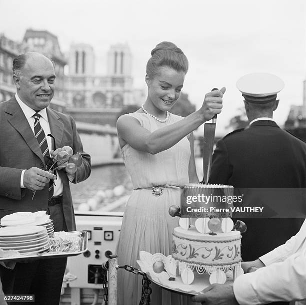 Austrian actress Romy Schneider and Italian movie producer Carlo Ponti attend a party on a boat for the 1962 Italian film Boccaccio '70 . The film...