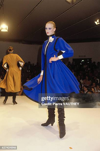 Fashion model wears haute couture women's fashions by designer Gianfranco Ferre for his Italian fashion house during a 1982-1983 Fall-Winter fashion...