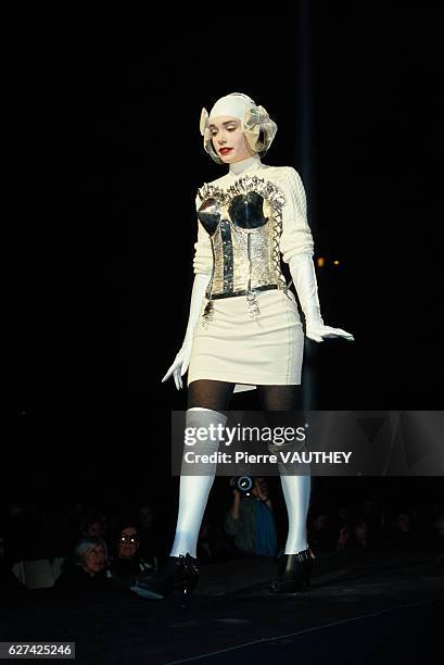 Fashion model walks along the runway in the latest ready-to-wear women's line by French fashion house Jean-Paul Gaultier at the 1987-1988 Fall-Winter...