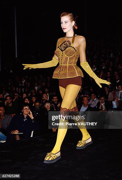 Fashion model wears a bustier with hot pants and leggings by French fashion designer Jean-Paul Gaultier at his spring-summer 1988 fashion show in...