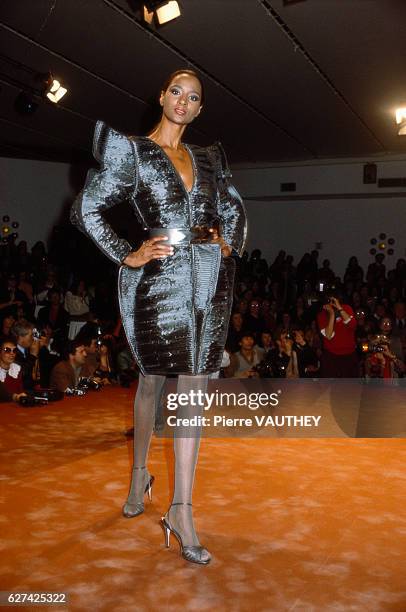 Fashion model wears ready-to-wear women's fashions by Krizia for her Italian fashion house during a 1982-1983 Fall-Winter fashion show in Milan. She...