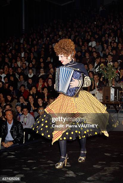 French accordionst and entertainer Yvette Horner performs for the crowd wearing a skirt and shirt by French fashion designer Jean-Paul Gaultier at...