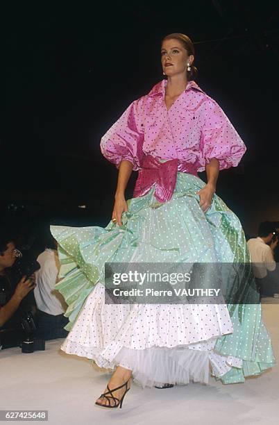 Fashion model wears a light pink and green ready-to-wear evening gown with polka dots and a bow by Italian fashion designer Gianfranco Ferre for...