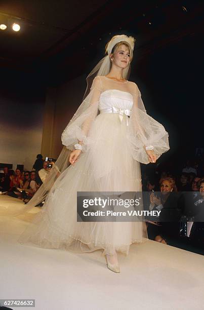 Fashion model Claudia Schiffer wears a haute couture wedding dress by German fashion designer Karl Lagerfeld for French fashion house Chanel. She...